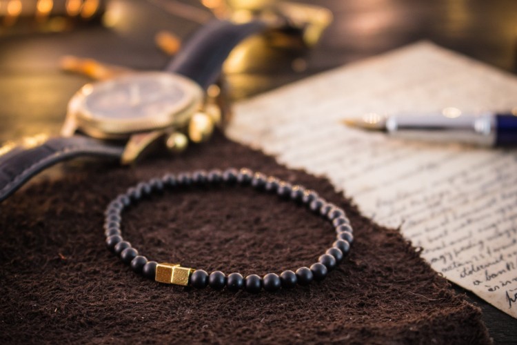 Stevan - 4mm - Matte Black Onyx Beaded Stretchy Bracelet with Gold Cube Beads from STRAPSANDBRACELETS