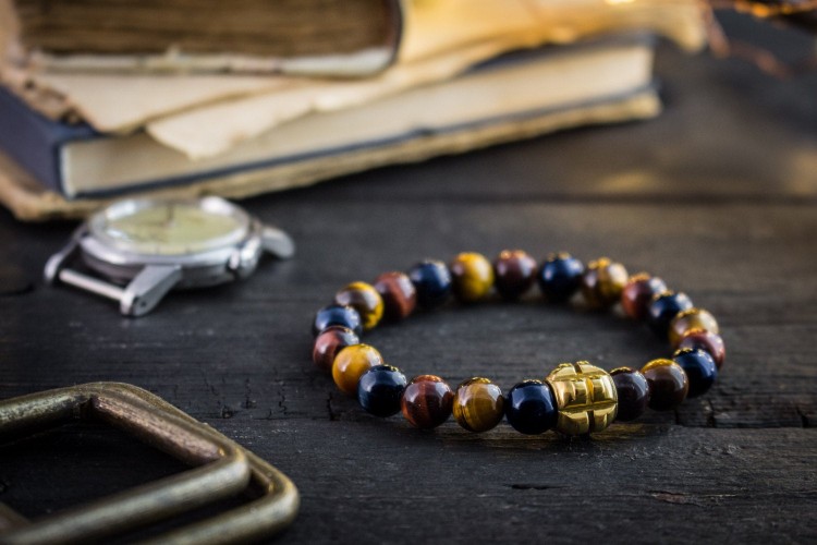 Rishi - 8mm - Blue, Red and Brown Tiger Eye Beaded Stretchy Bracelet with Gold Grenade Bead from STRAPSANDBRACELETS