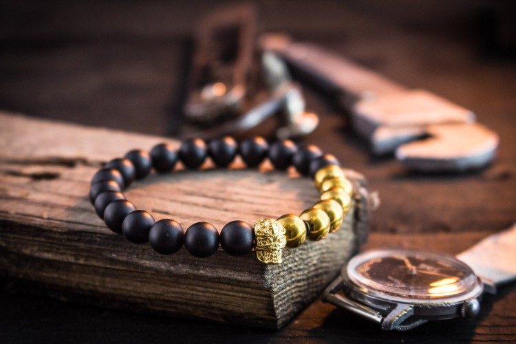 Laucklan - 8mm - Matte Black And Gold Beaded Stretchy Bracelet with Gold Skull from STRAPSANDBRACELETS