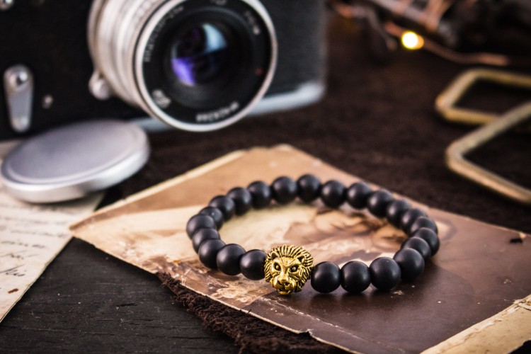 Thando - 8mm - Matte Black Beaded Stretchy Bracelet with Gold Lion from STRAPSANDBRACELETS