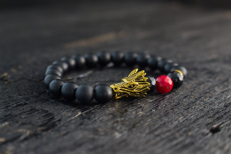 Sami - 8mm - Matte Black Onyx Beaded Stretchy Bracelet With Gold Dragon Head & Faceted Red Imitation Coral Bead from STRAPSANDBRACELETS