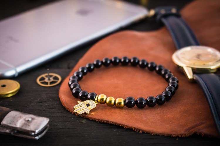 Reighan - 6mm - Black Onyx Beaded Stretchy Bracelet with Gold Micro Pave Hamsa Hand Charm from STRAPSANDBRACELETS